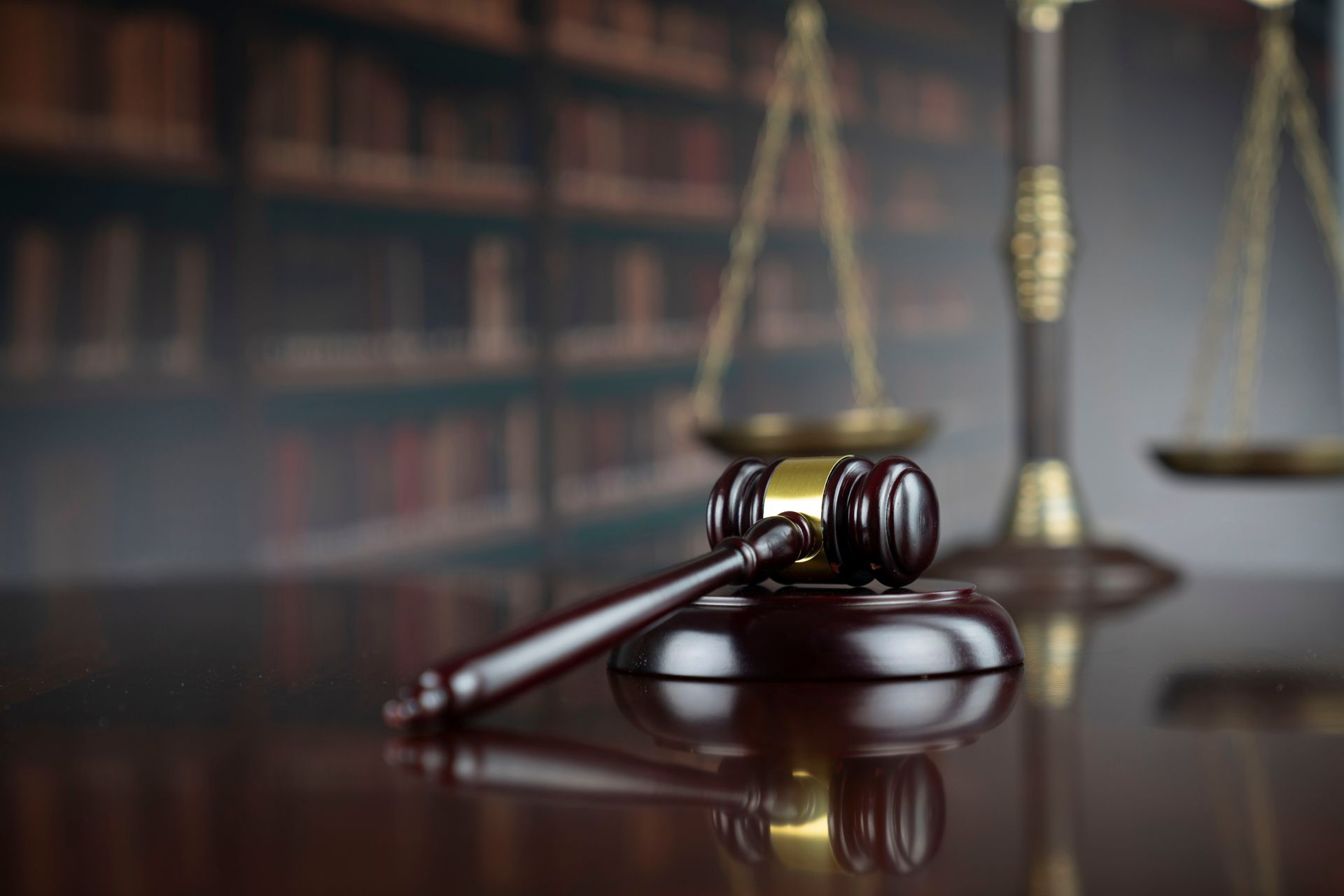 A Judge 's Gavel and Scales of Justice Are on a Wooden Table