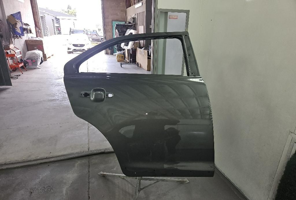 Newly Painted Car Door in a Workshop — T&C Smash Repairs In Coffs Harbour, NSW