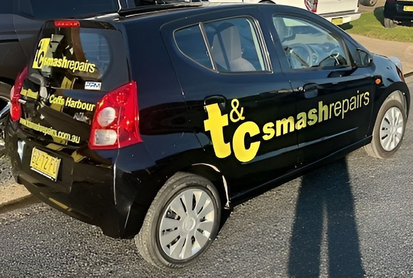 Black Car With a Business Signage — T&C Smash Repairs In Coffs Harbour, NSW