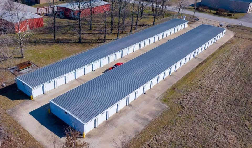 An aerial view of a row of storage units in a field.