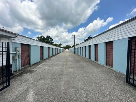 A row of storage units are lined up on the side of a road.