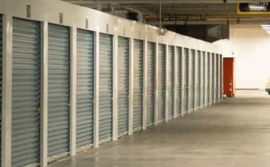 A row of empty storage units in a warehouse.