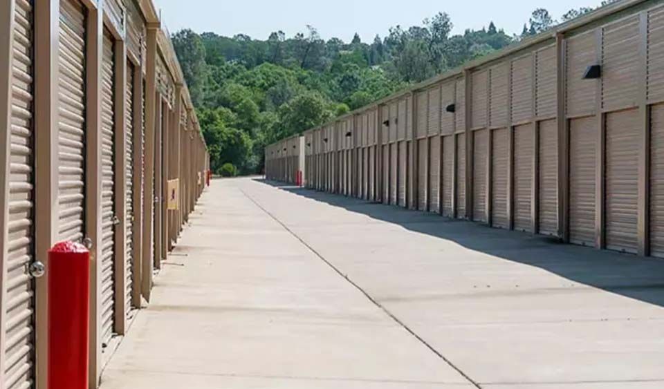 A row of storage units lined up next to each other on a sidewalk.