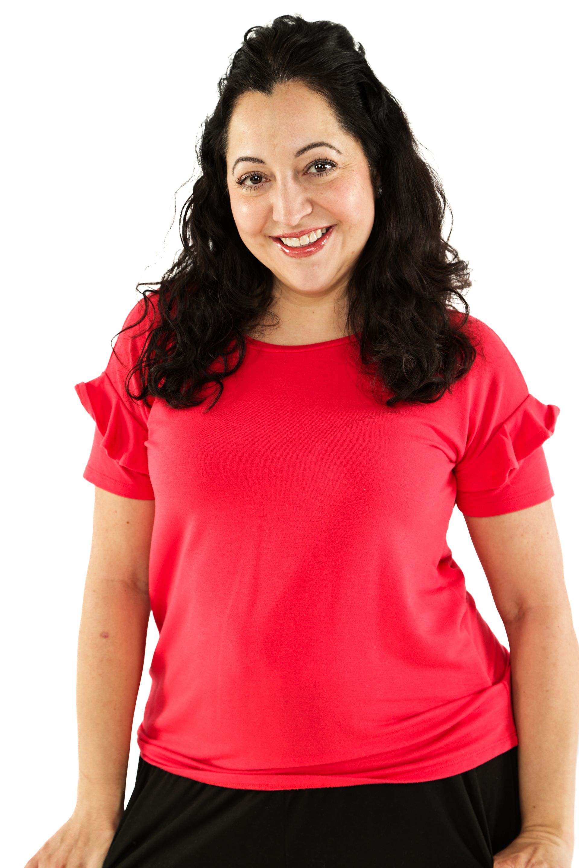Woman with curly dark hair wearing a bright red shirt, smiling against a white background