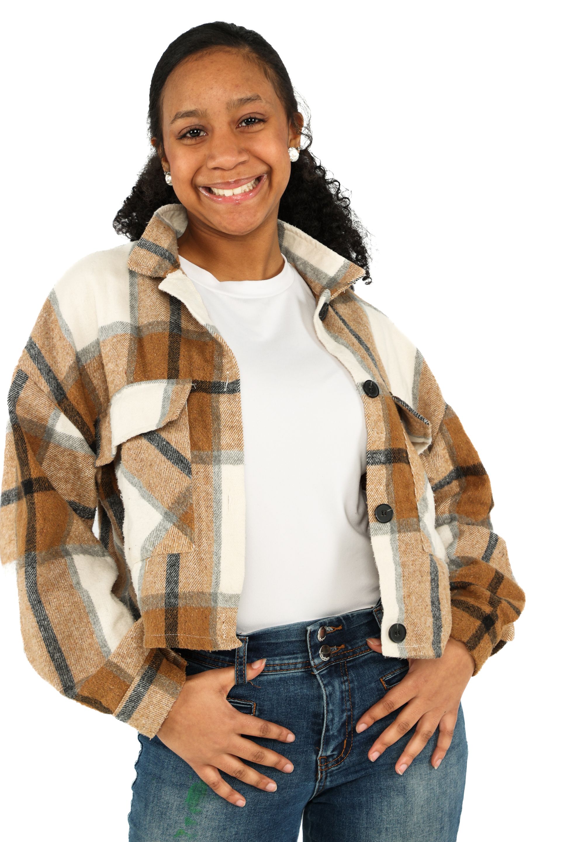Smiling person wearing a tan plaid jacket, white shirt, and jeans, standing against a white background
