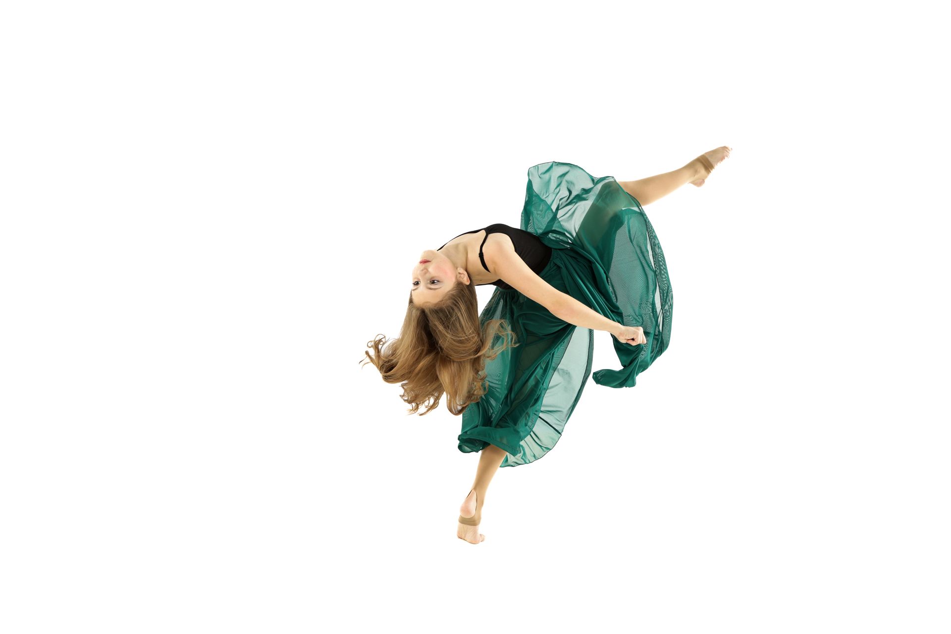 Dancer in a flowing green dress mid-air against a white background