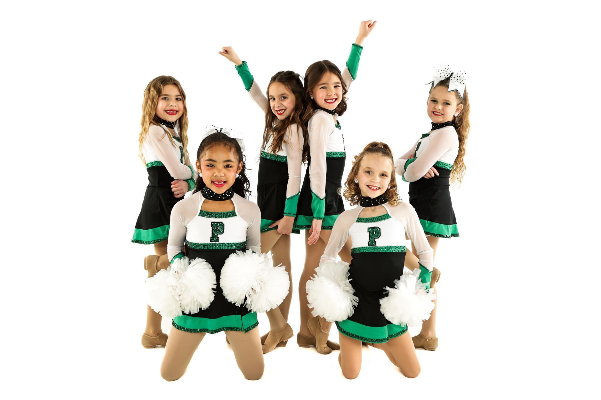 Six young cheerleaders in green and white uniforms posing with pom-poms against a white background