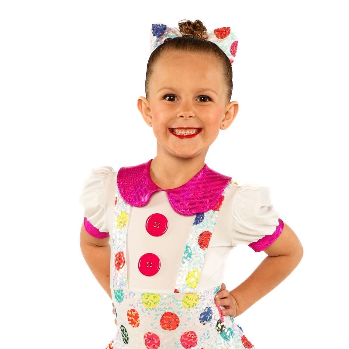 Child in a colorful clown costume smiling with hands on hips against a white background