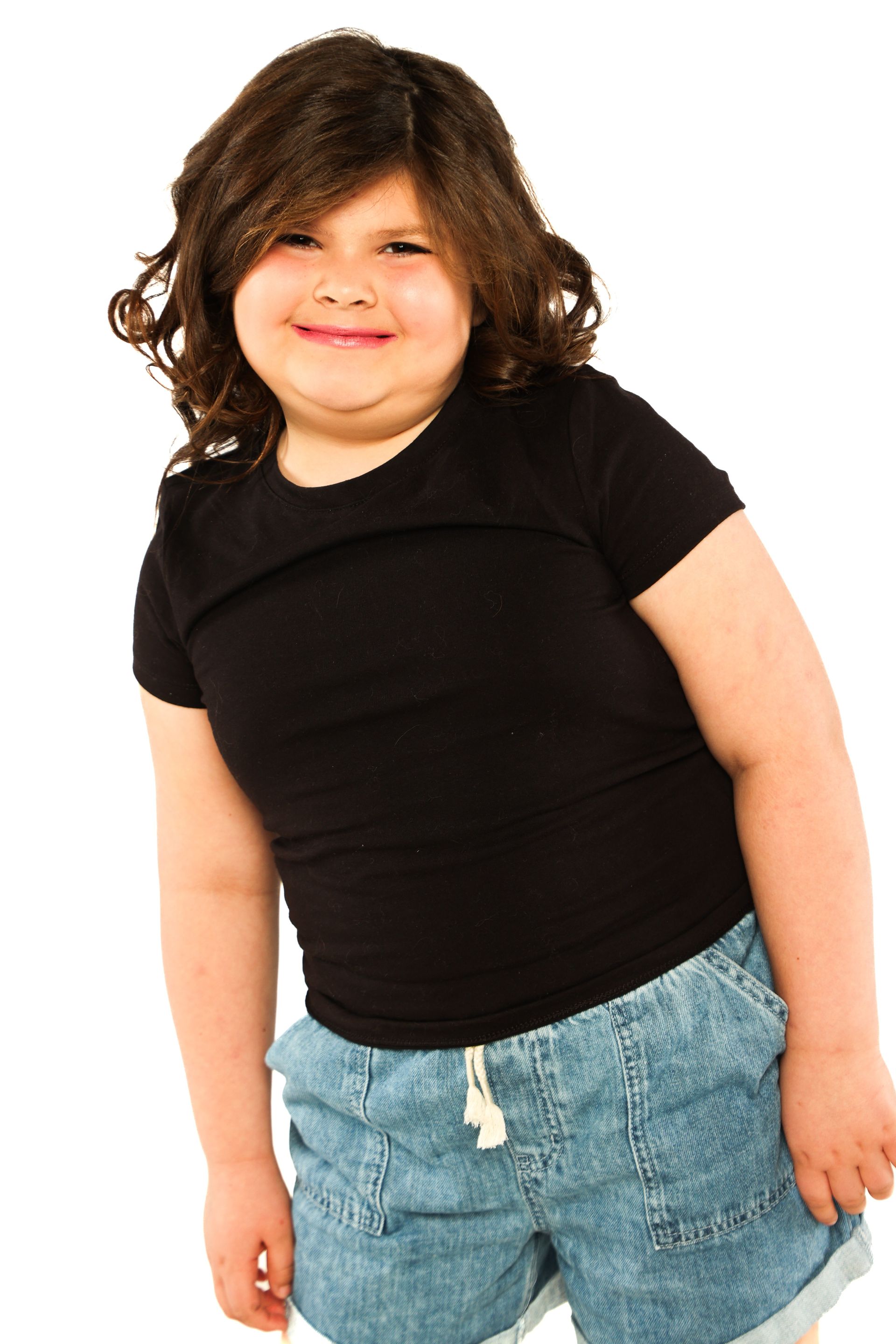 Person wearing a black shirt and blue jeans standing against a white background