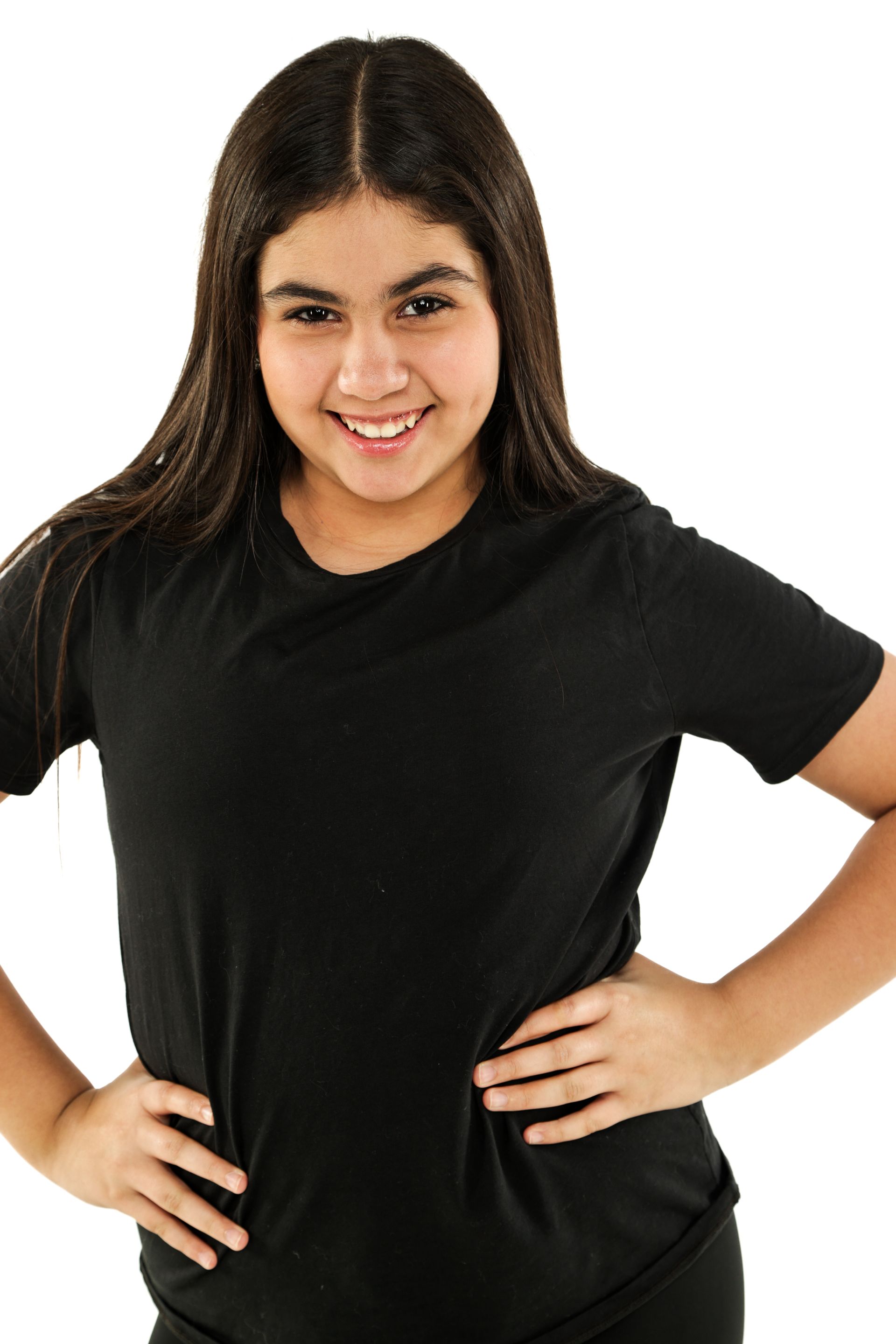 Smiling person in a black shirt standing with hands on hips against a white background