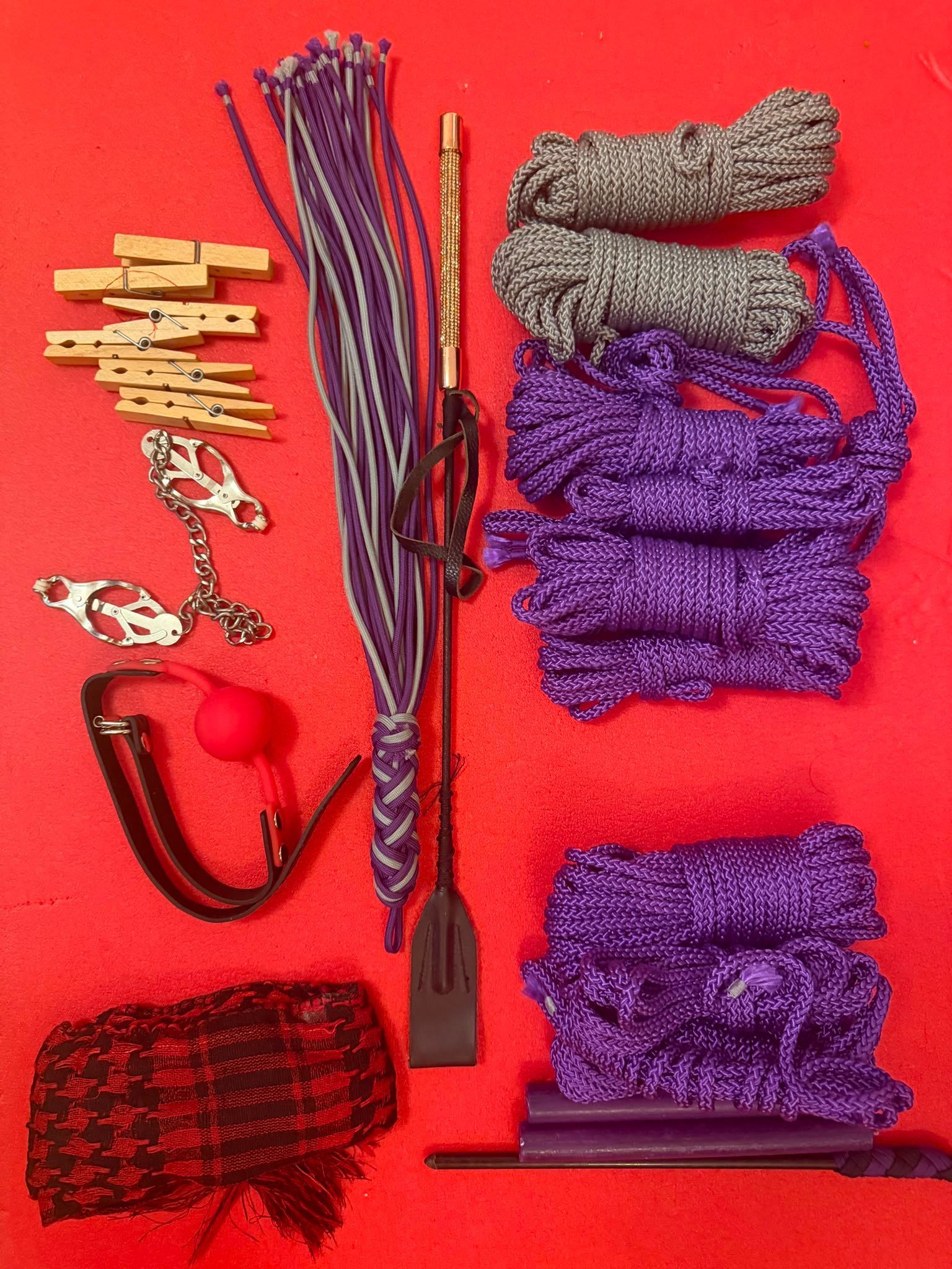 Selection of BDSM equipment including rope, floggers, paddles, restraints and accessories used during a Dominatrix & Sub Experience.