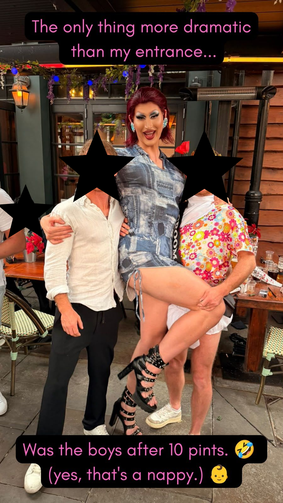 Babs Amore drag queen being lifted by the stag dressed as a big baby in a nappy during a fun handcuffed stag party bar crawl in Cardiff