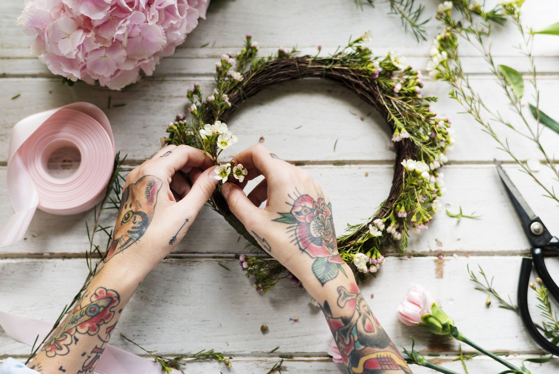 Flower crown crafting workshop with hands creating floral headpieces