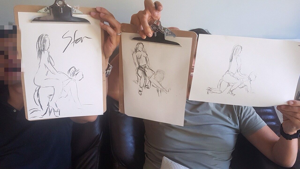 Stag party guests holding up their humorous life drawing sketches during a fun and cheeky stag do experience. A unique and interactive life drawing session with playful poses, laughter, and creative entertainment