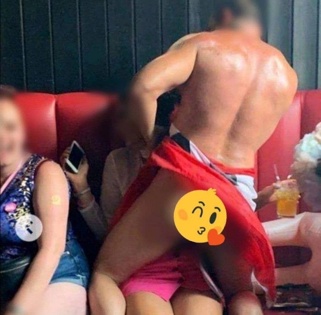 Male strip performer interacting with guests during a hen party show