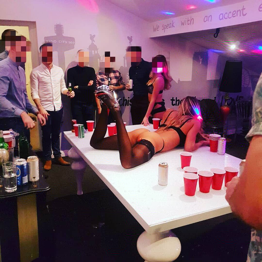 Sexy hostesses playing beer pong with the stags in Leeds