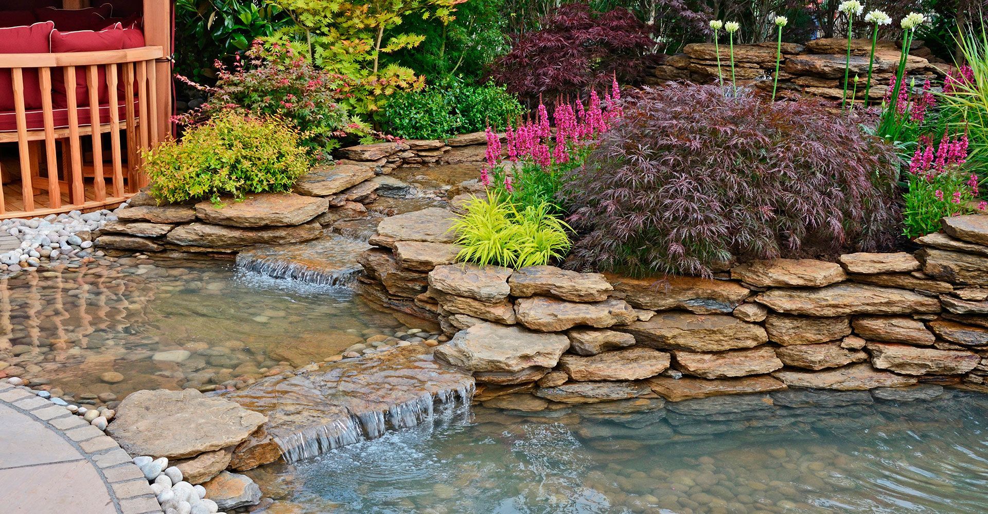 There is a waterfall in the middle of the garden.