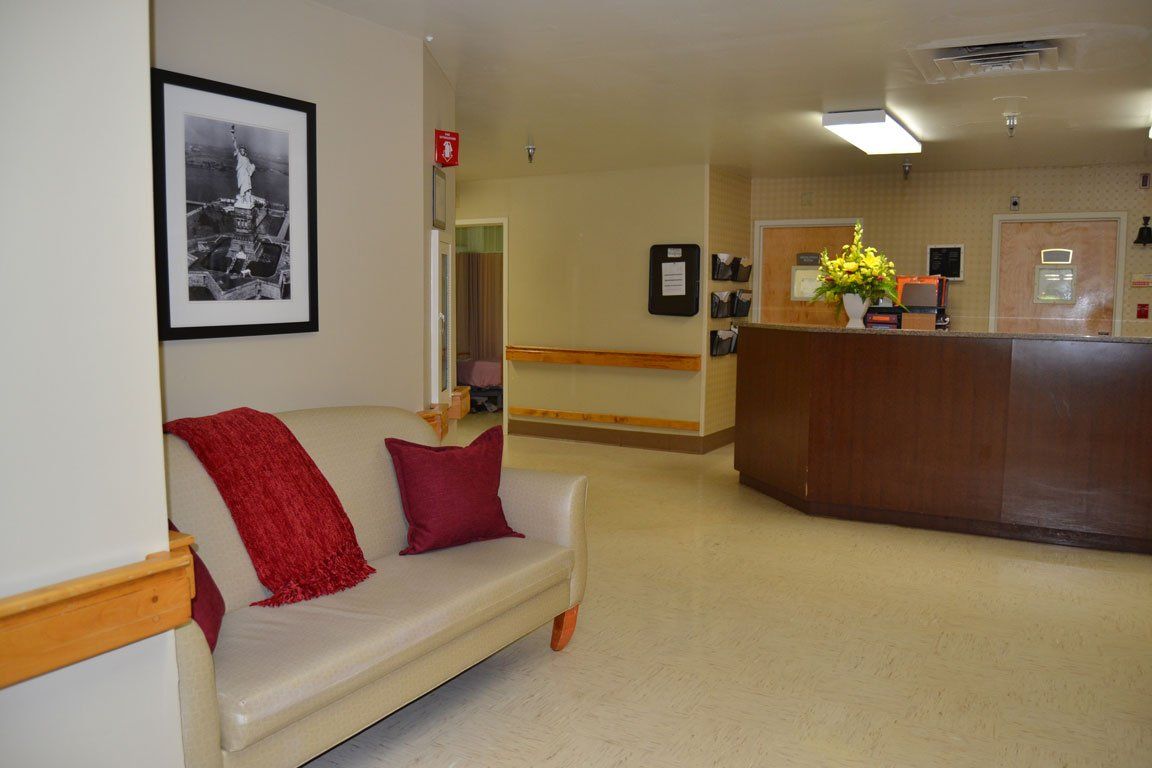 A living room with a couch and a picture on the wall