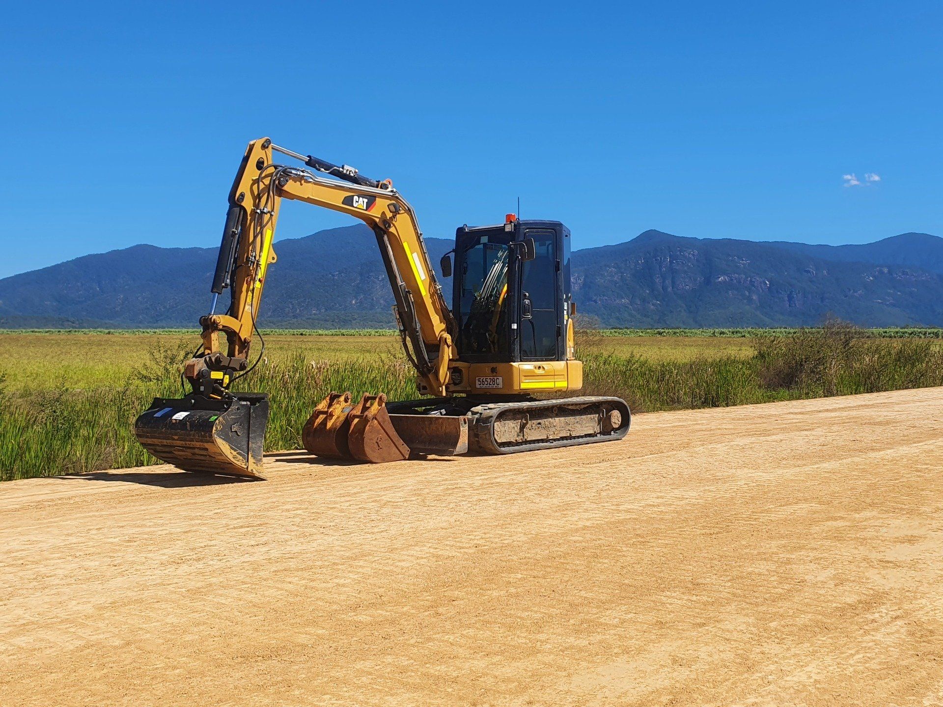 An Excavator Digging On A Site — Providing Communications and Hydro Excavation Services in Townsville, QLD
