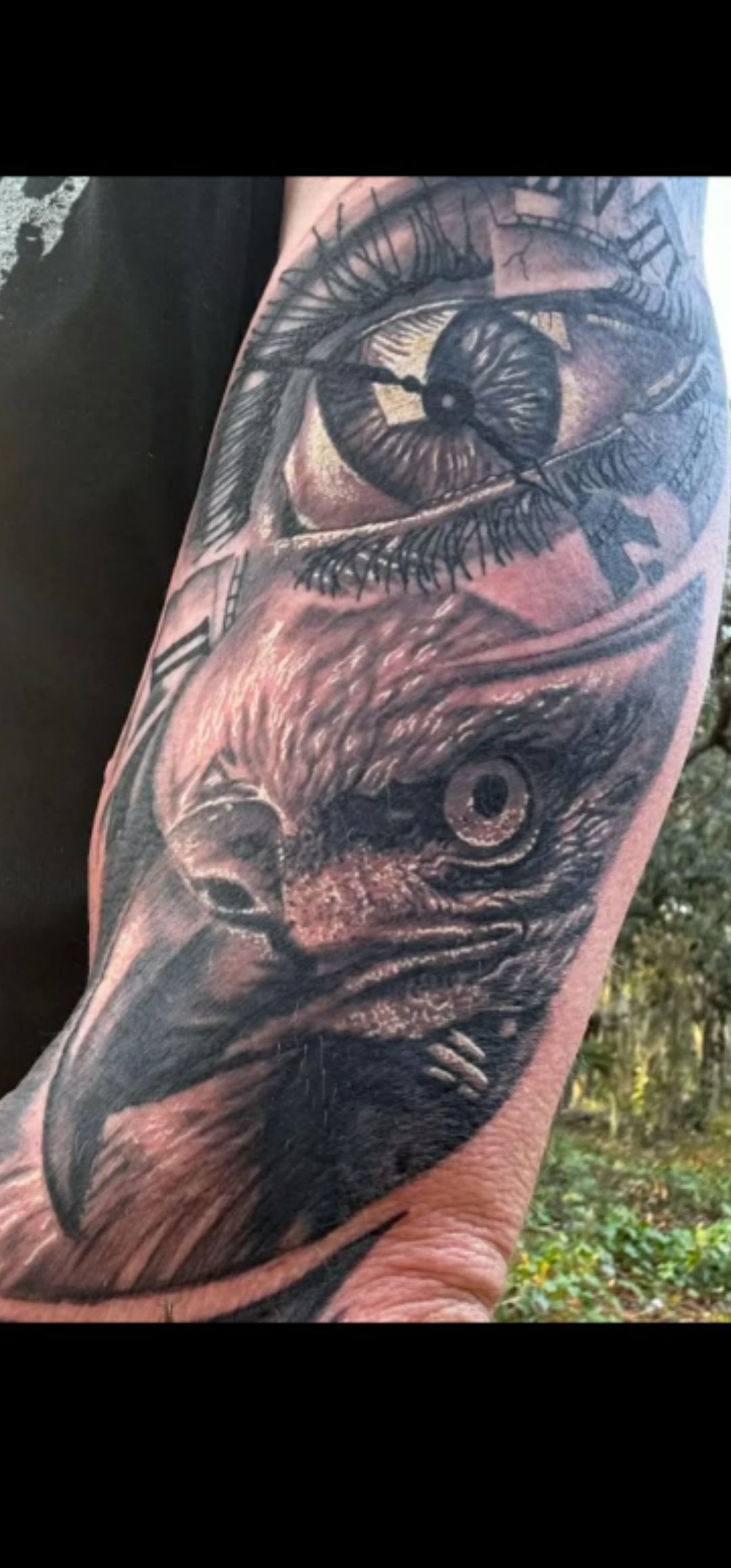 Close-up of a black-and-gray tattoo sleeve with an owl and a crescent moon on an arm
