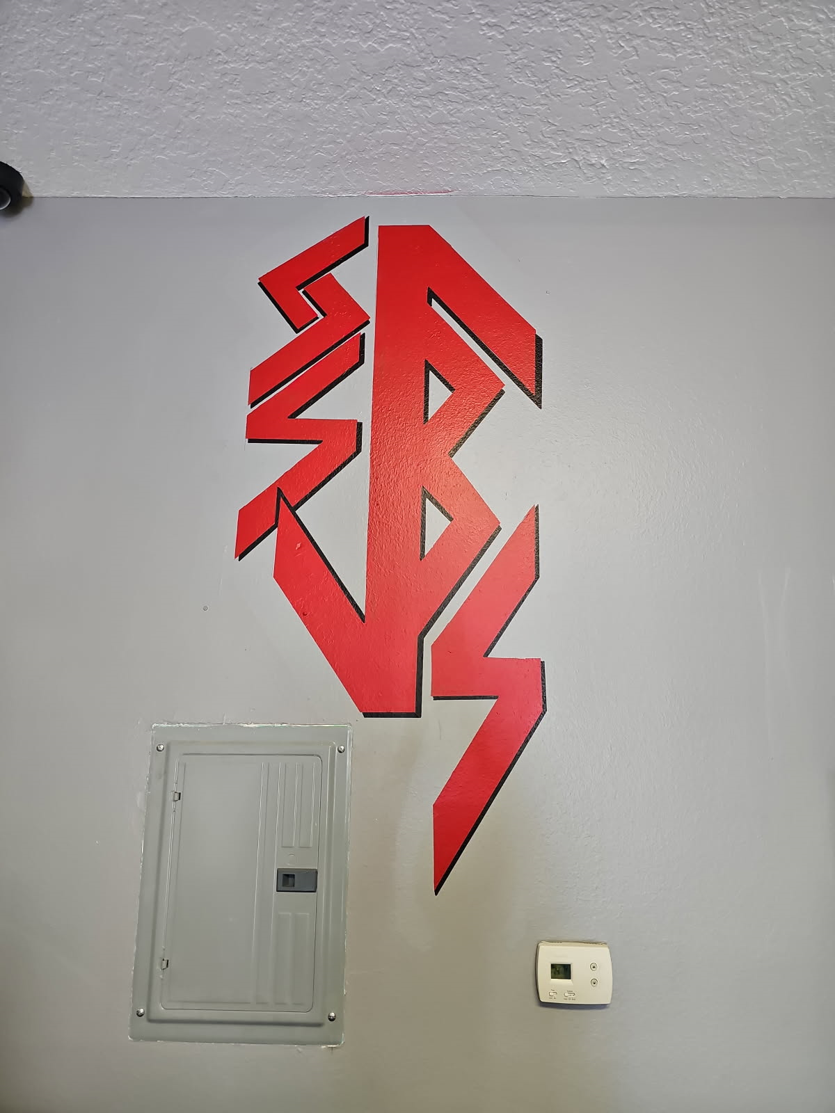 A wall with a red lightning bolt on it