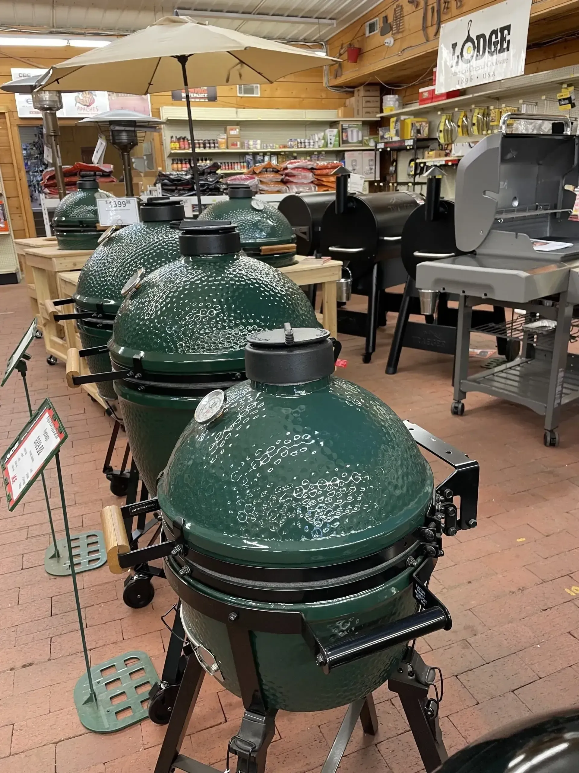 A row of green grills are lined up in a store.