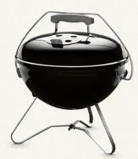 A small black grill with a handle on a white background
