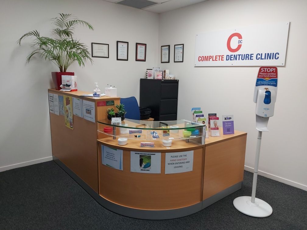 A Dental Office With a Counter and a Sign That Says Complete Denture Clinic — Complete Denture Clinic in Kanwal, NSW