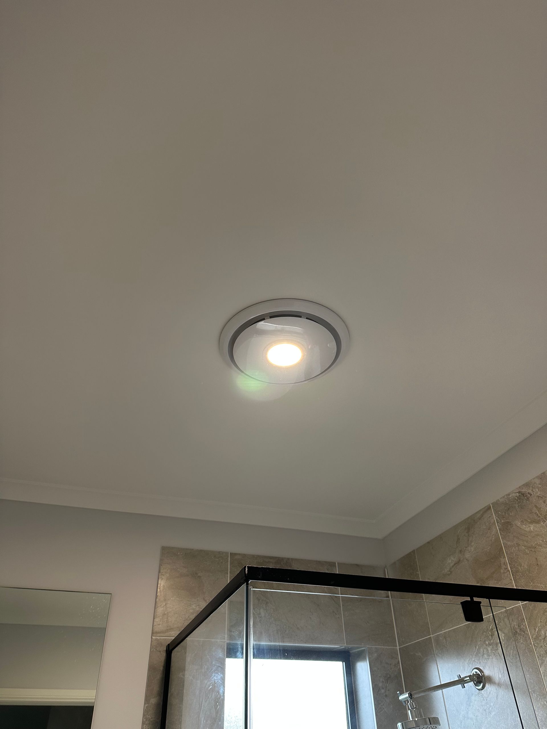 Ceiling Light Fixture in a Bathroom. White Ceiling, Circular Light — SparkSafe Electrical in Kiama, NSW
