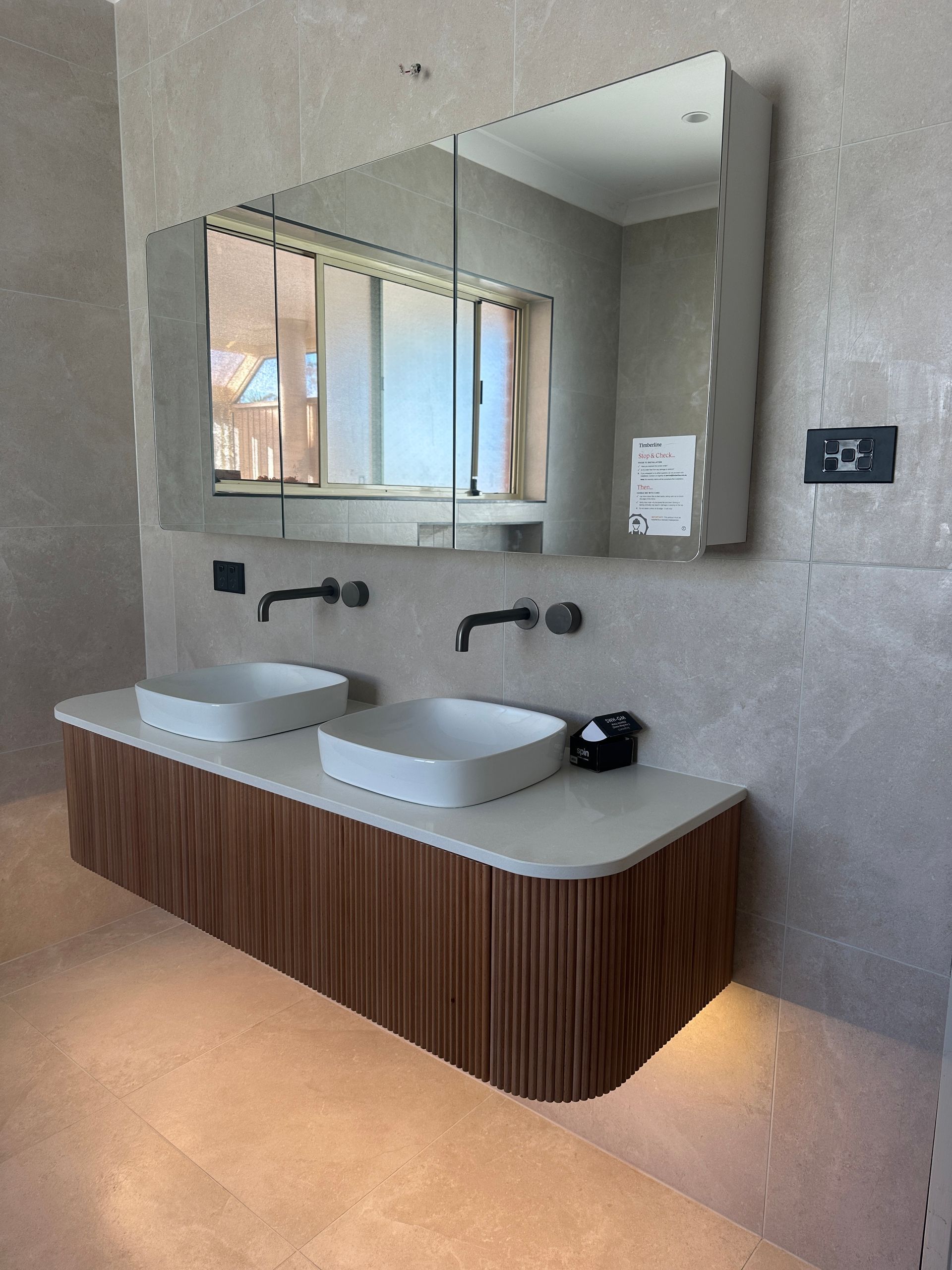 Modern Bathroom With Double Sinks and a Large Mirror. Brown Wood Vanity — SparkSafe Electrical in Dapto, NSW