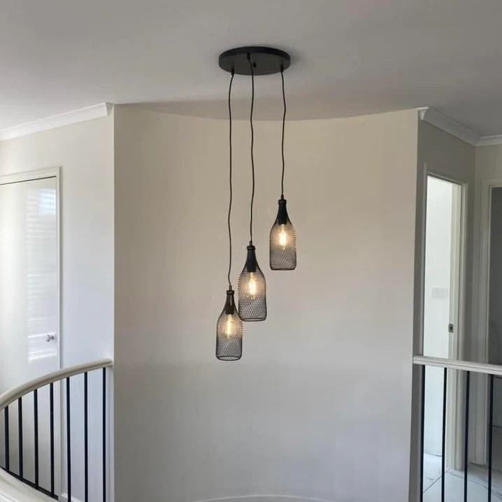 Three Hanging Pendant Lights With Exposed Cords in a White Stairwell Area — SparkSafe Electrical in Bulli, NSW