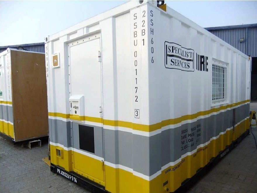White, grey, and yellow office container with a door, window, and business name.