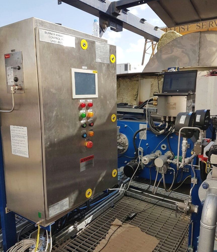 Industrial control panel with touchscreen and buttons beside blue machinery in a factory setting providing Water, Bath and Heater manufactured by Centurion Middle East