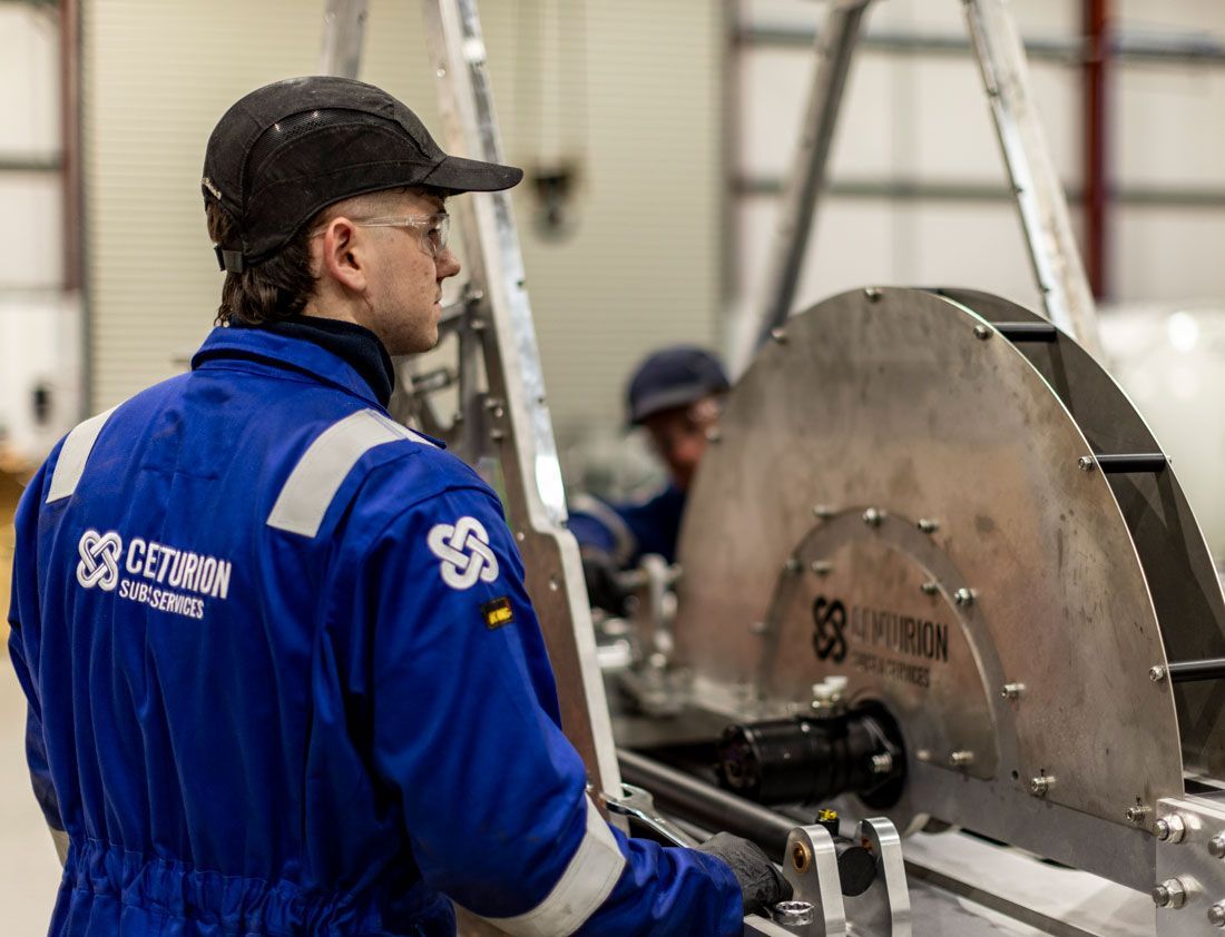 Worker in blue uniform designing and manufacturing in a Centurion workshop.