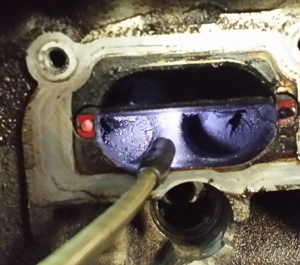 A close up of a purple object with a hose attached to it