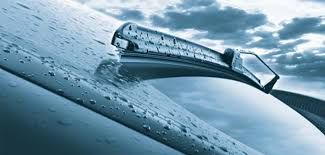 A close up of a windshield wiper on a car.