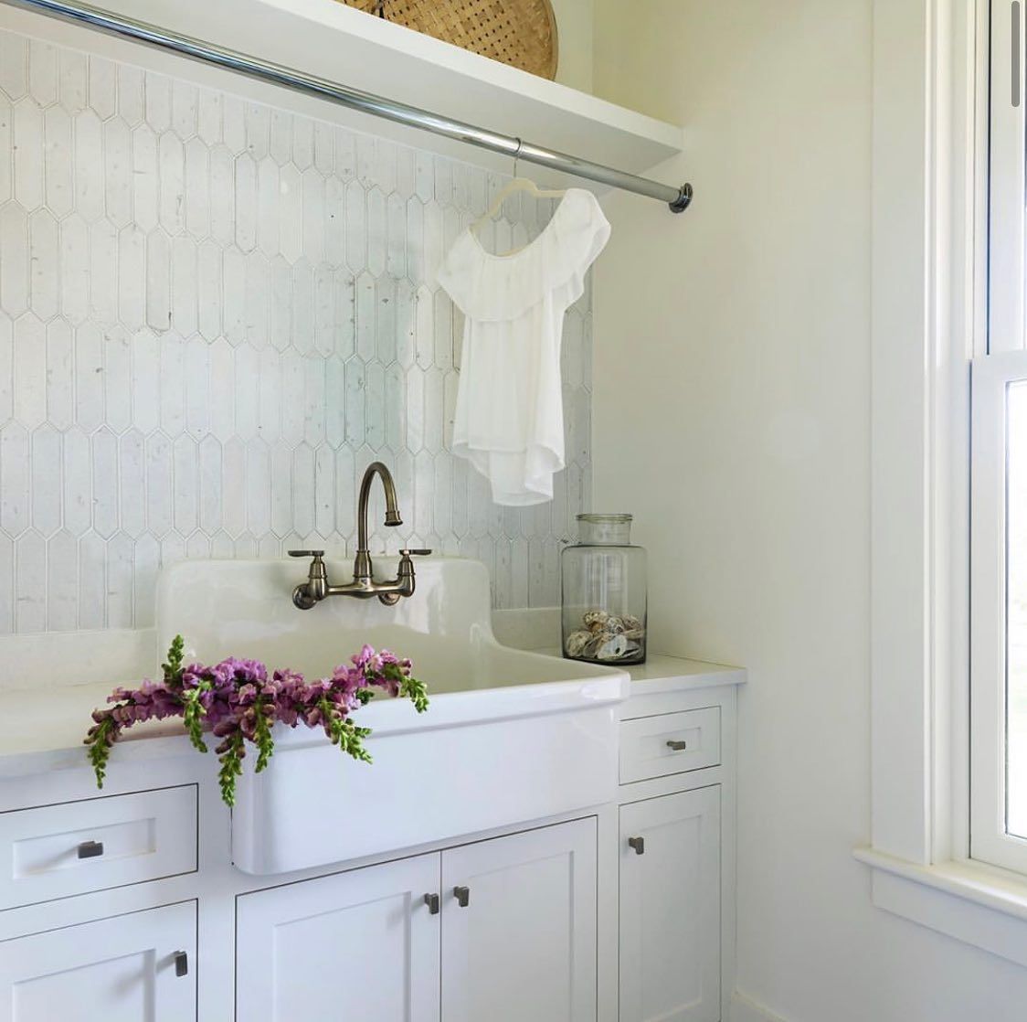 A laundry room with a sink and a window