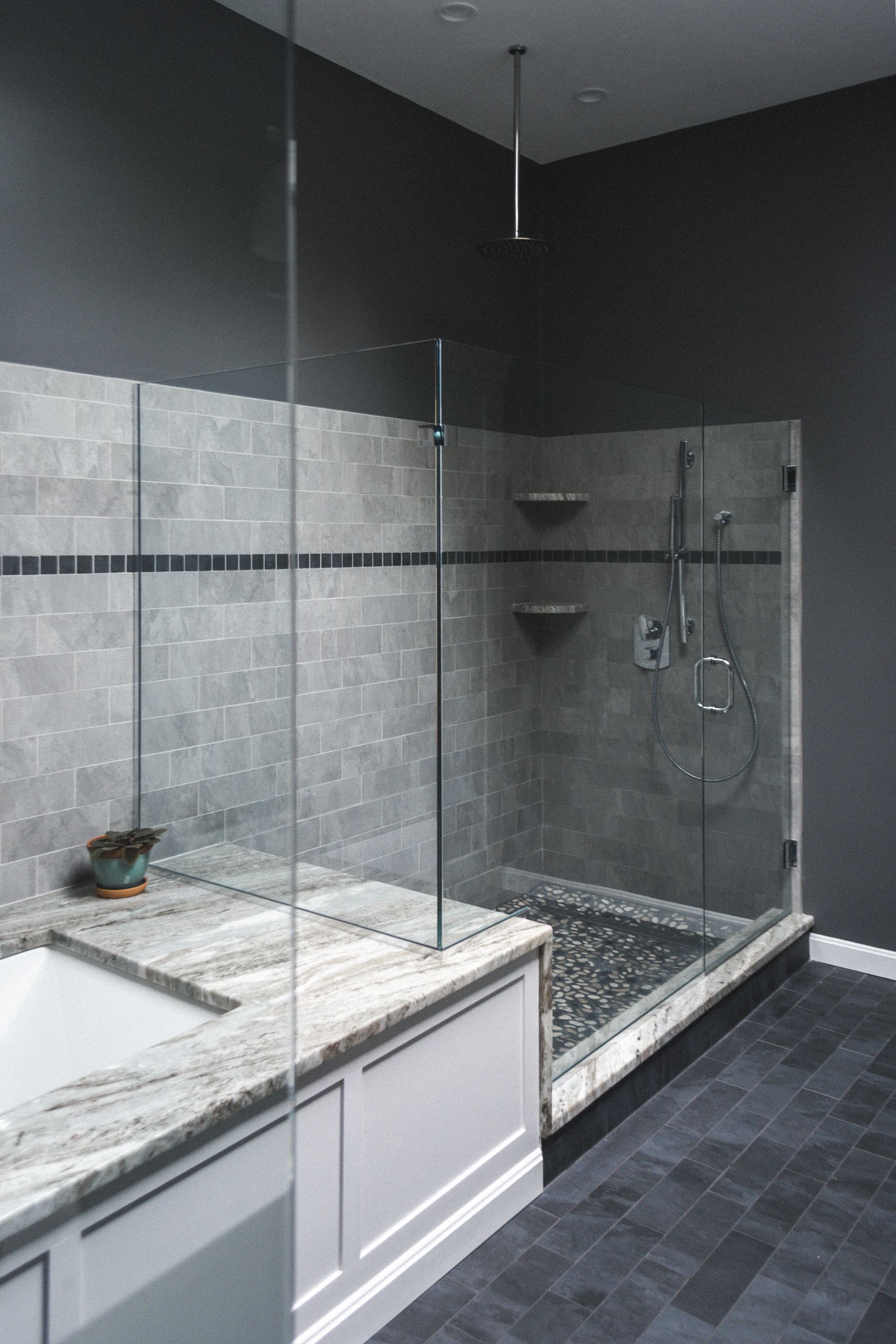 A bathroom with a walk in shower and a bathtub