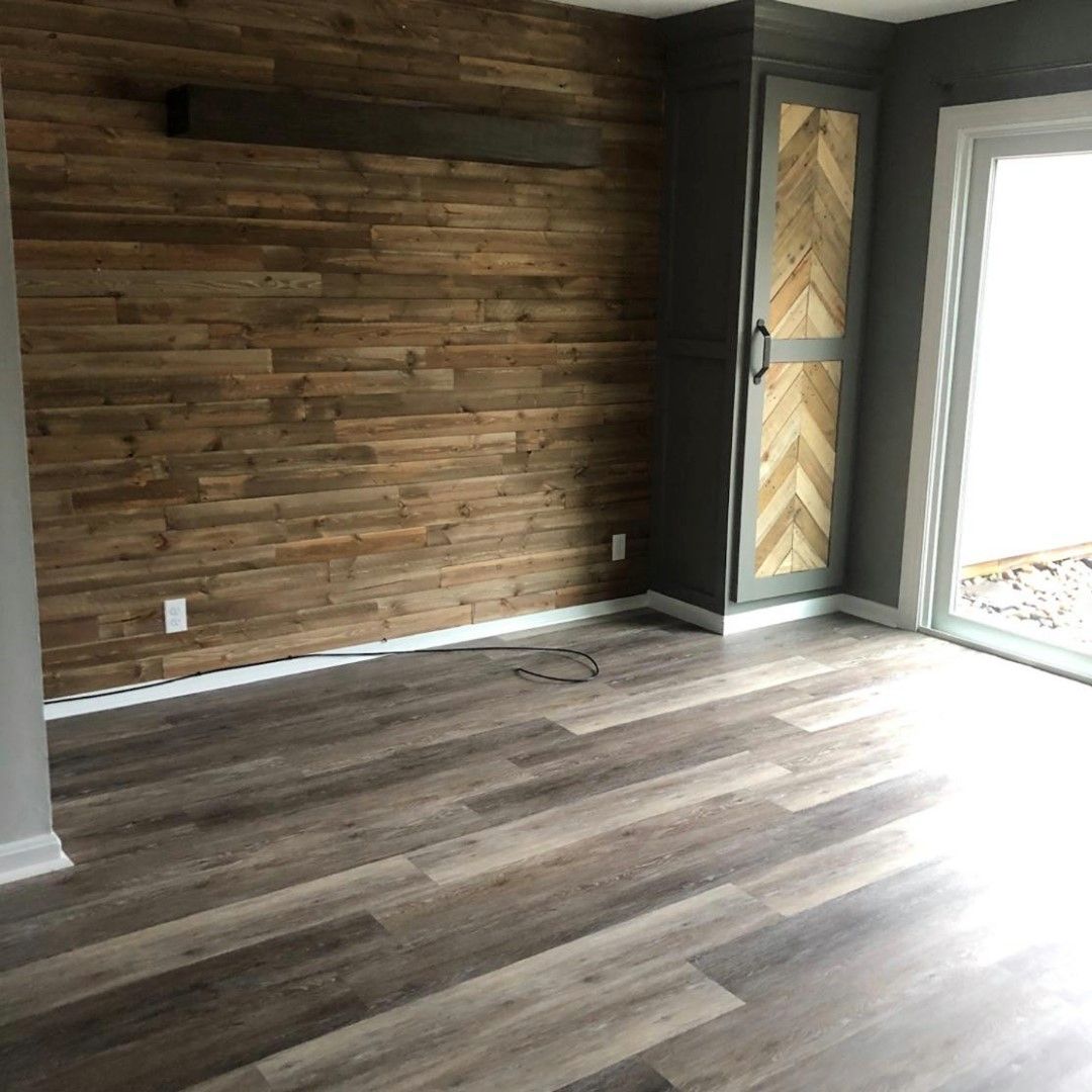 A living room with hardwood floors and a wooden wall