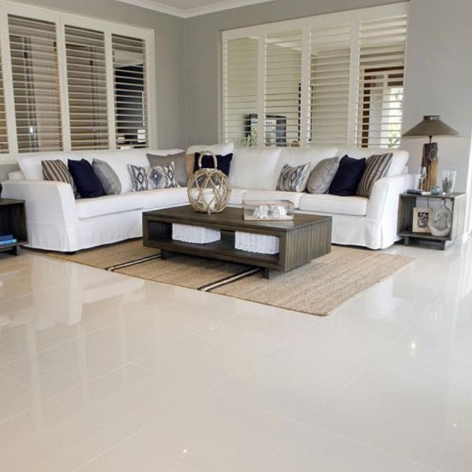 A living room with two white couches and a coffee table