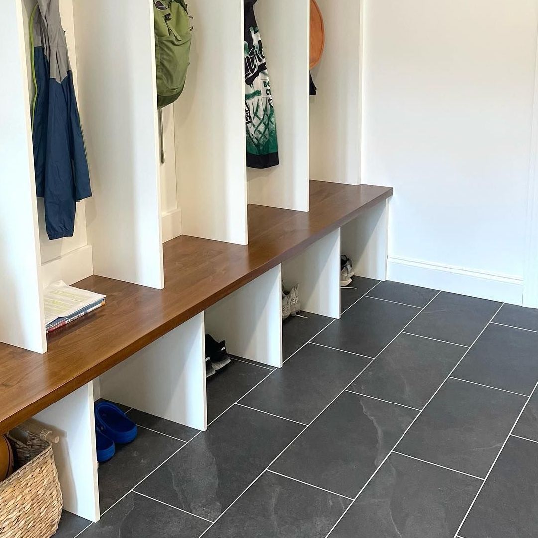 A hallway with a bench and a basket on the floor