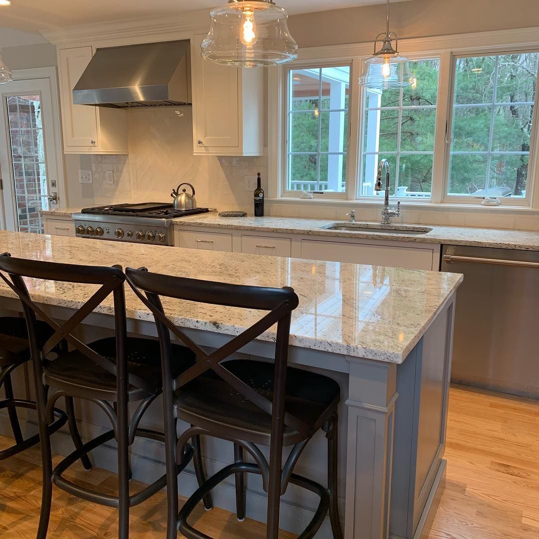 A kitchen with a large island and stools