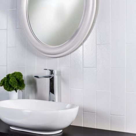 A bathroom with a sink , mirror and faucet.