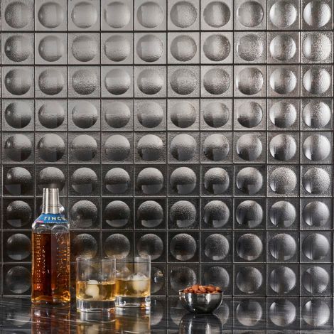 A bottle of whiskey and two glasses of whiskey are on a table.