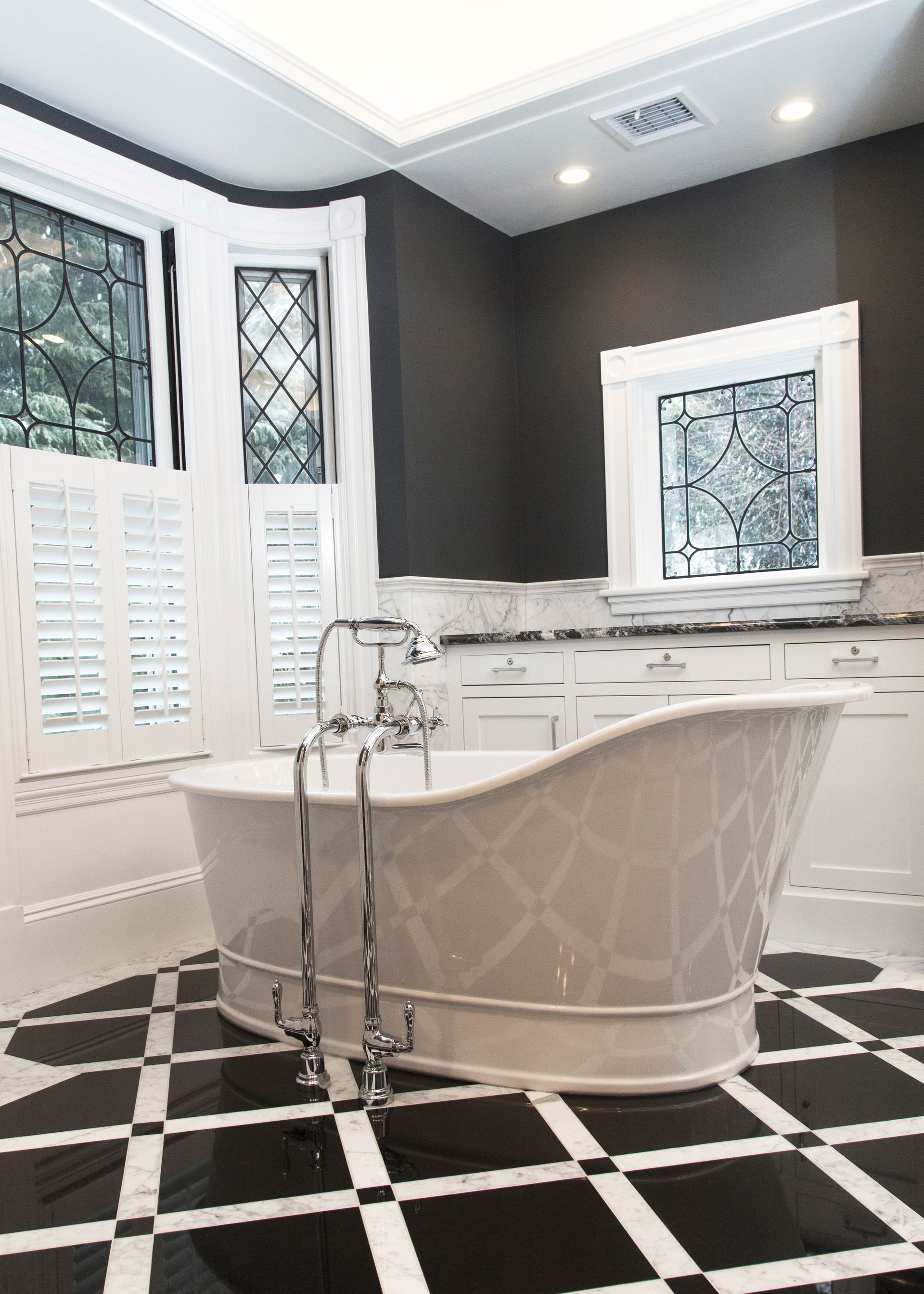 A bathroom with a bathtub and a checkered floor