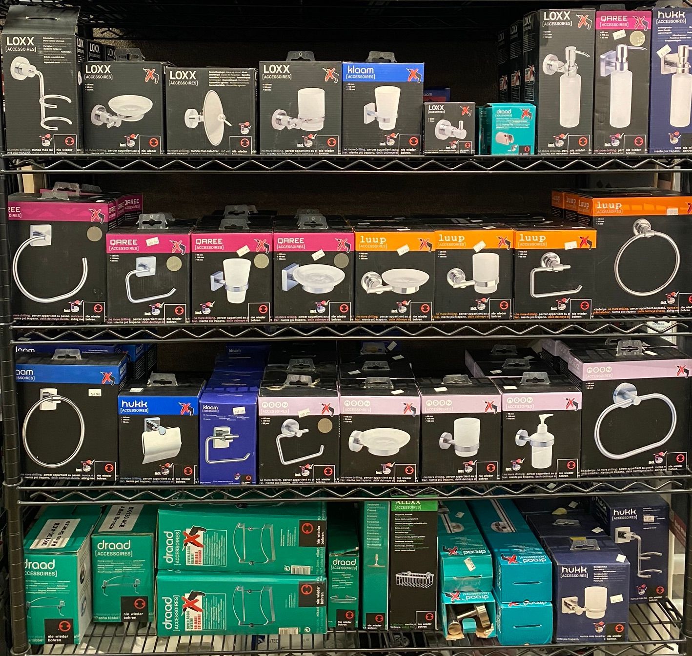 A shelf filled with lots of boxes including one that says ' lg ' on it
