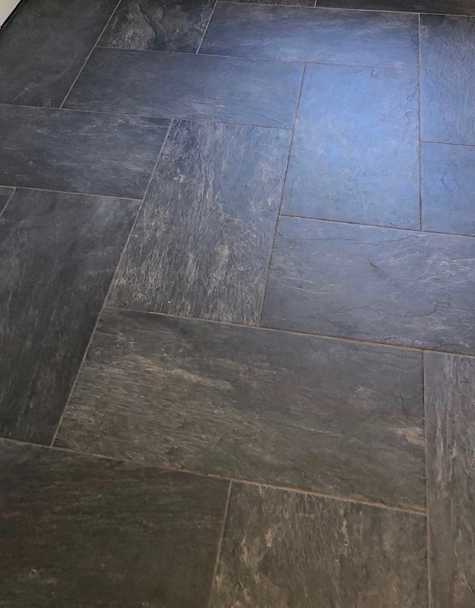 A close up of a tiled floor in a room.