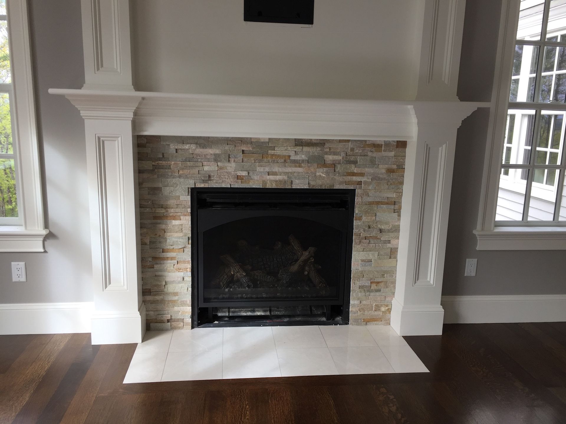 A living room with a fireplace and a window