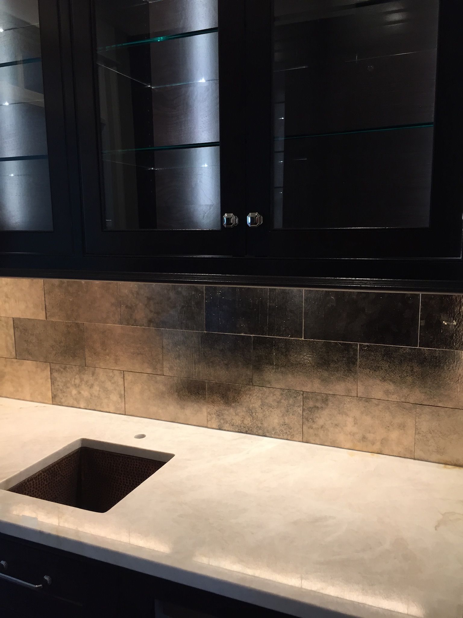 A kitchen with a sink , cabinets and a counter top.
