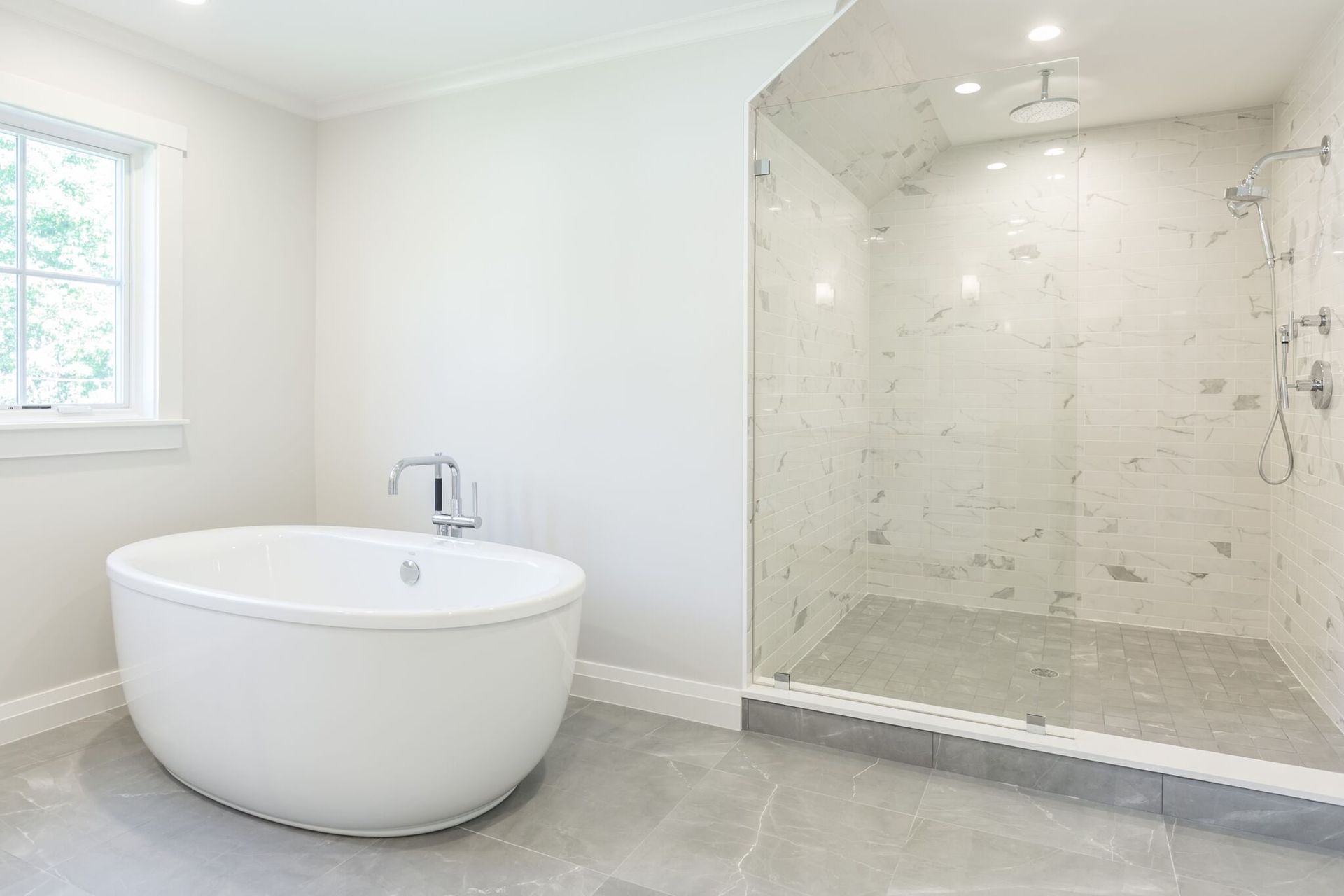 A bathroom with a tub and a walk in shower.
